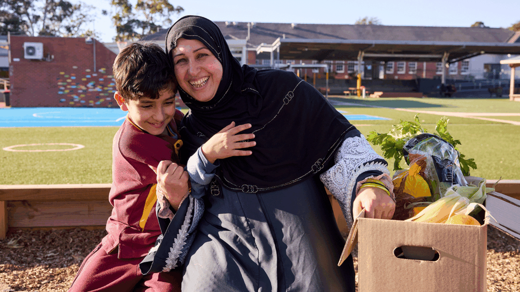 Family receiving a weekly fresh produce box from our charity The One Box