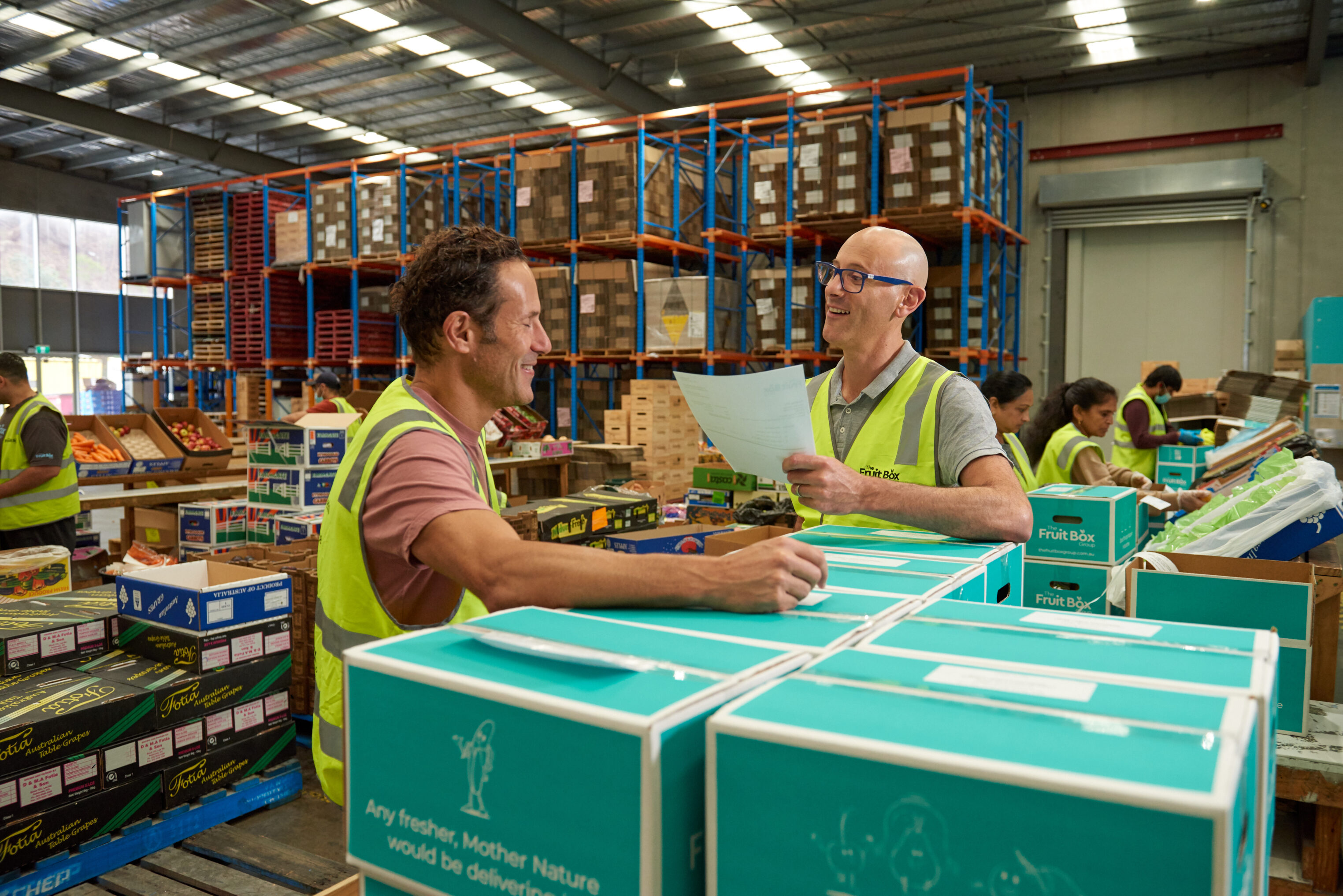 Fruit Box Group team members packing office fruit delivery orders