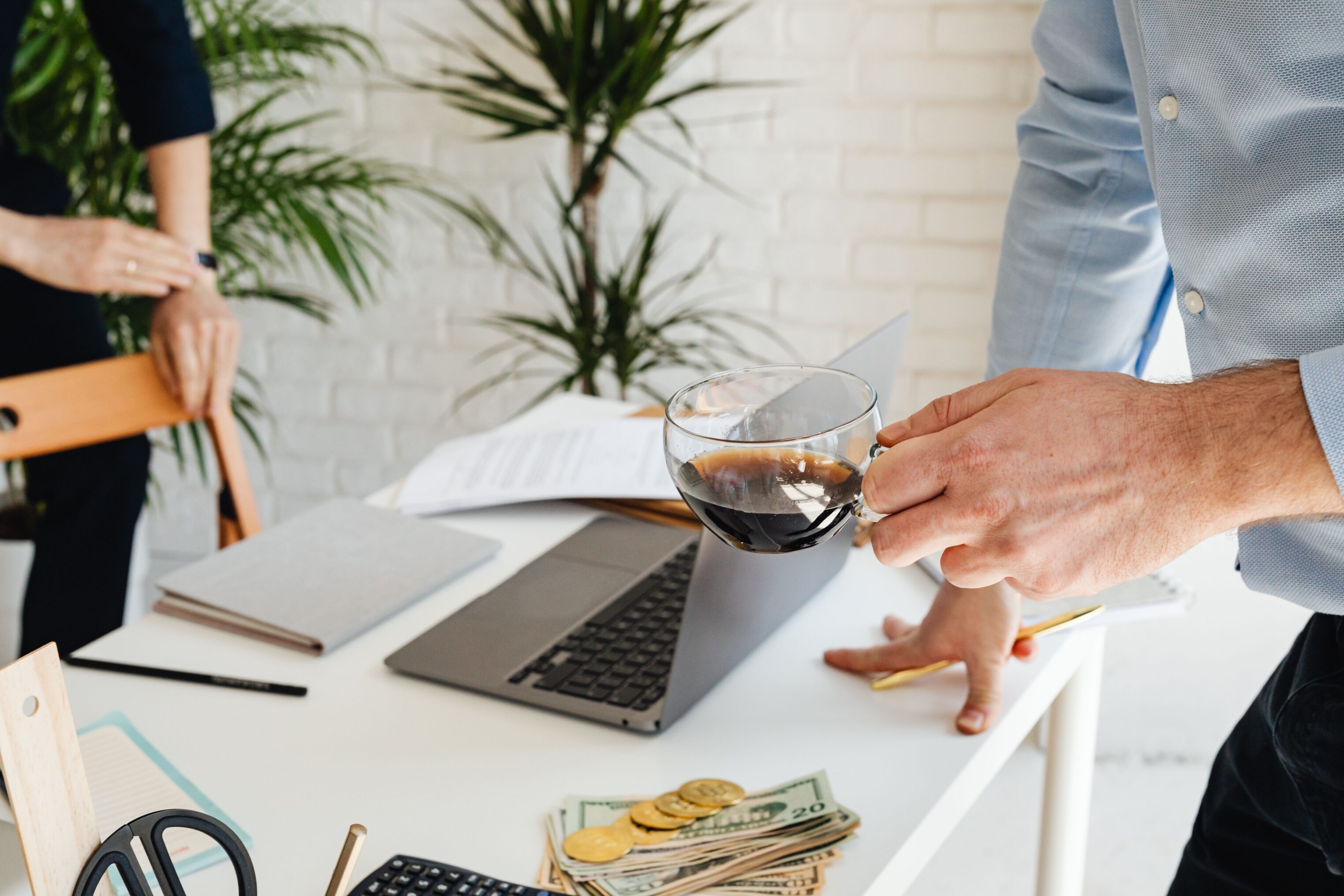 Person drinking coffee while working at office