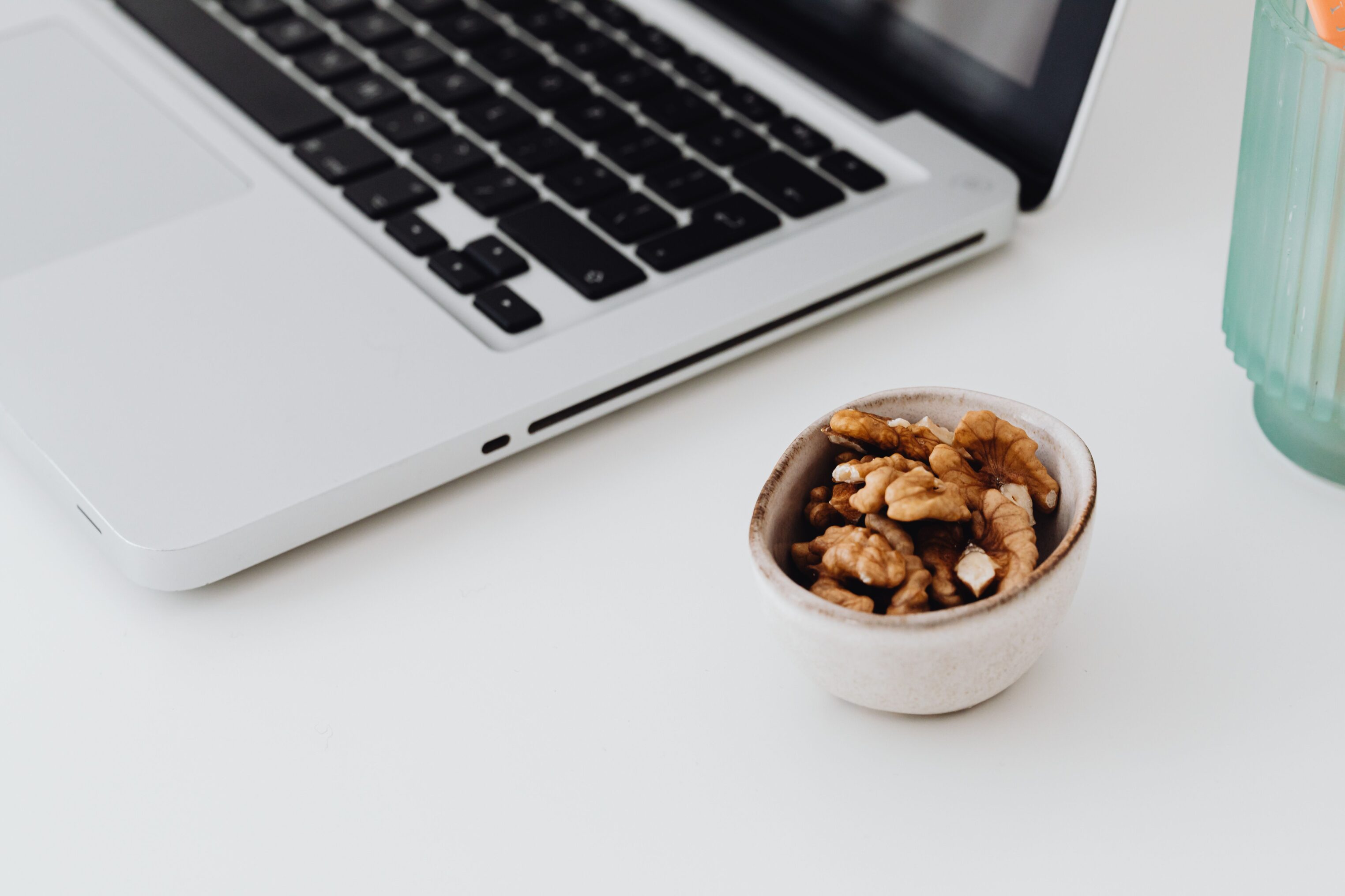 Bowl of office snacks next to laptop at work