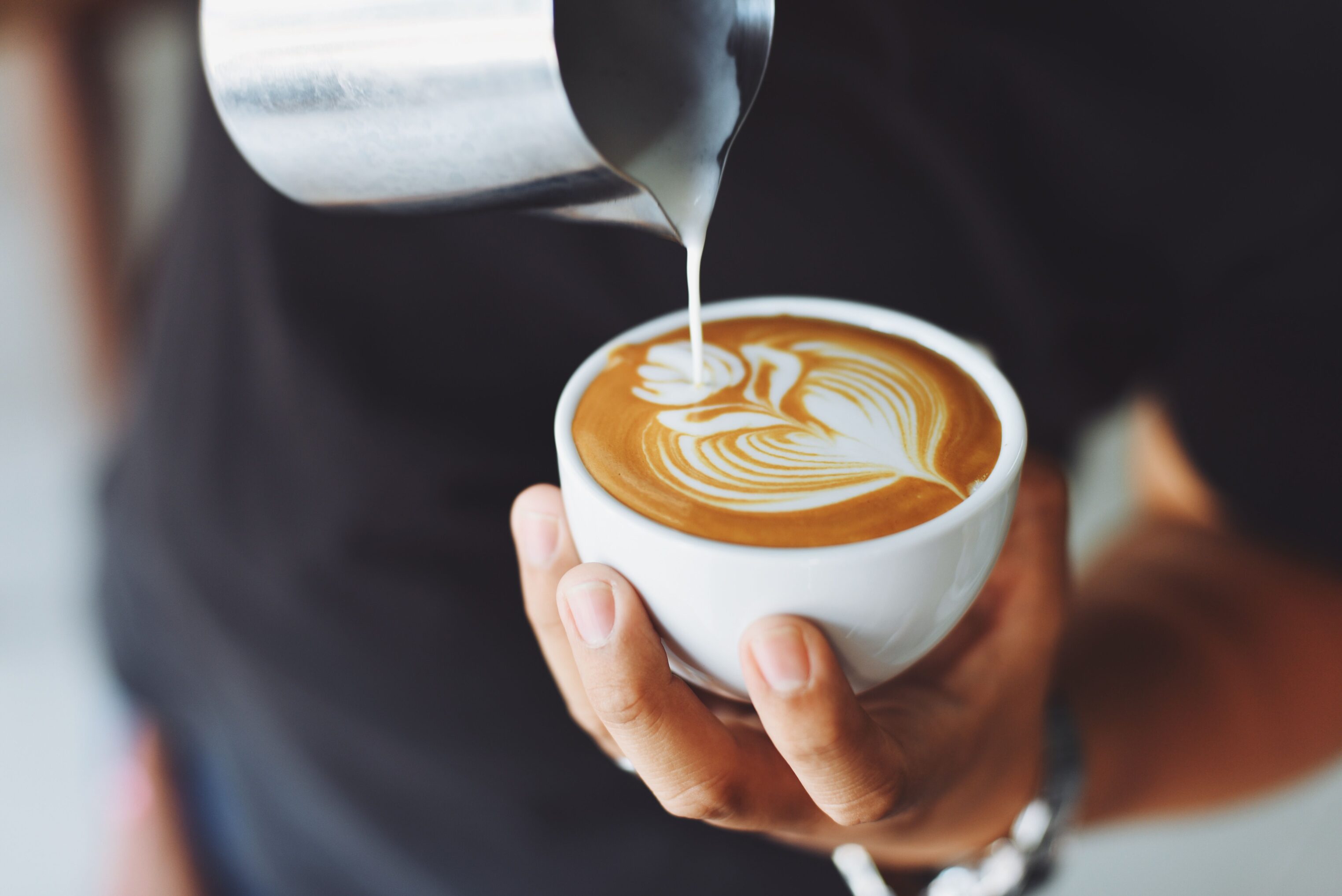Office worker pouring coffee in tearoom