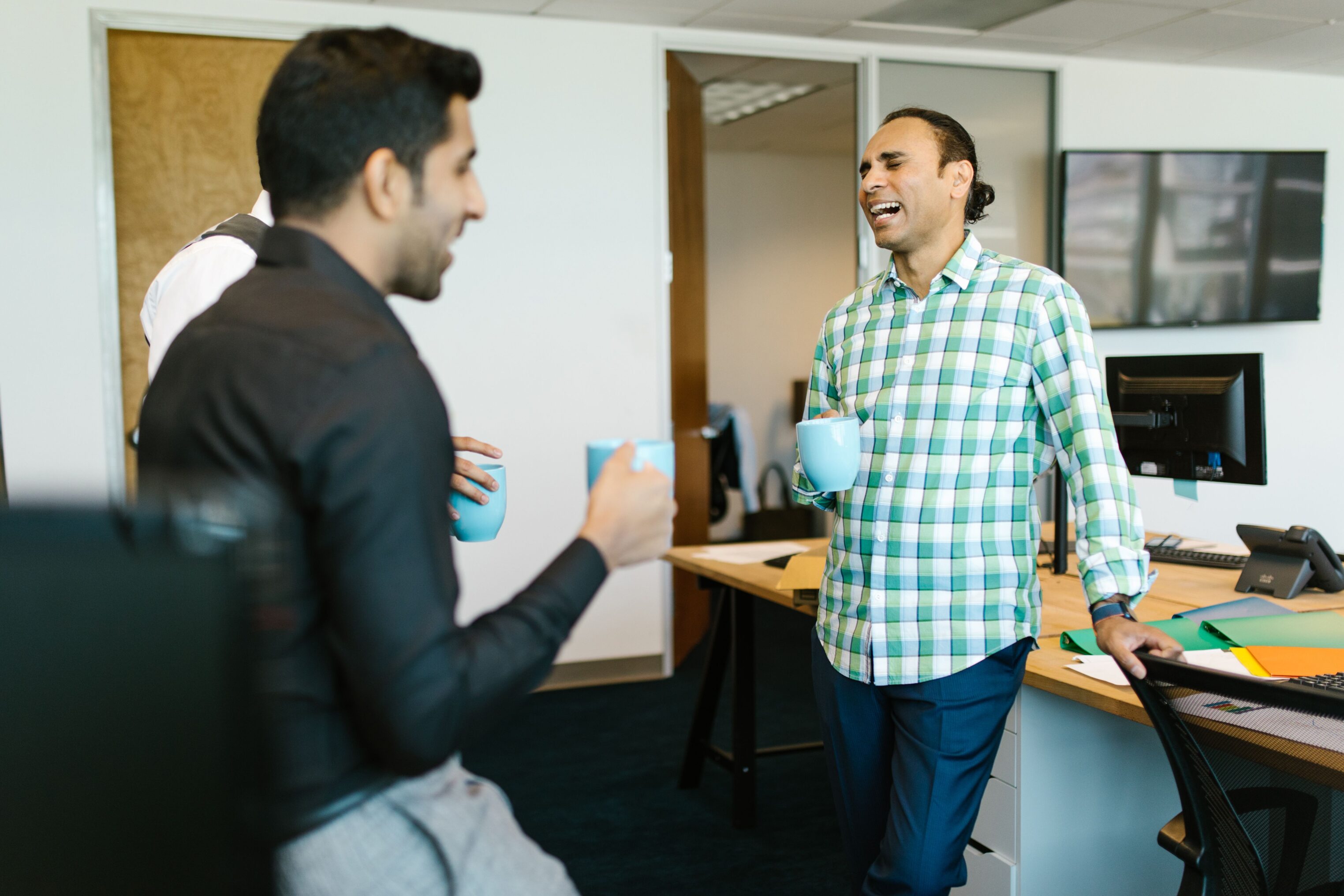 Office workers enjoy a coffee break together